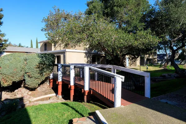 a view of a swimming pool with a garden and deck