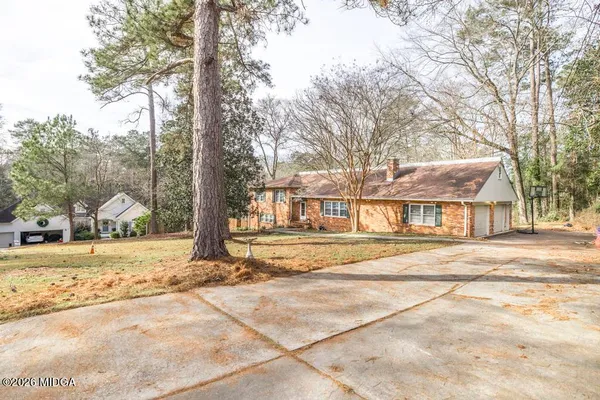 a view of a large trees in front of a house