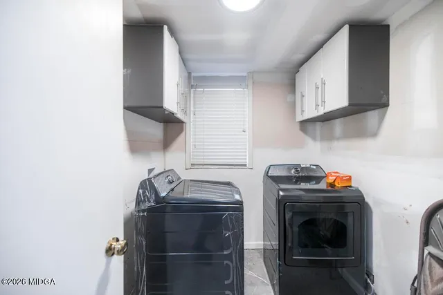 a utility room with closet dryer and washer