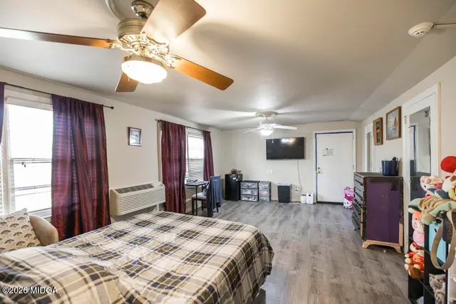 a bedroom with a bed and a chandelier