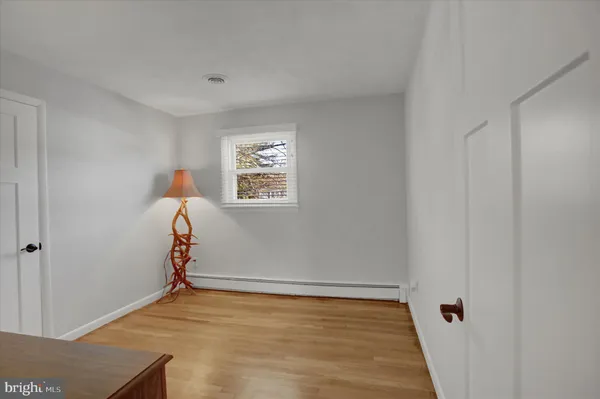 a view of a livingroom with wooden floor and a window