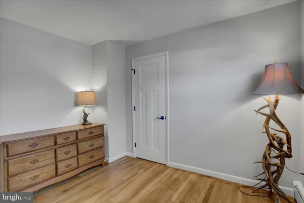 a view of room with wooden floor cabinet and a window