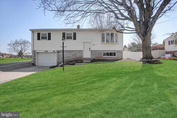 a front view of house with yard and green space