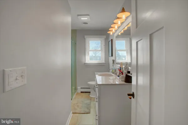 a bathroom with a sink mirror and window