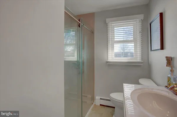 a white toilet sitting next to a bathroom sink