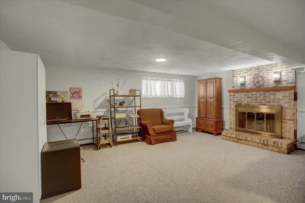 a view of a livingroom with furniture and a fireplace