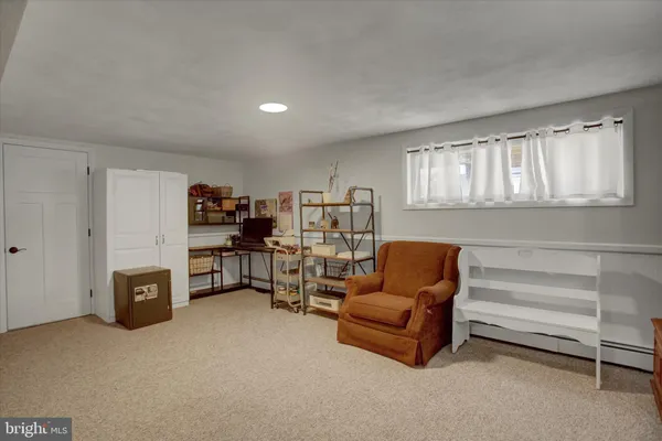 a living room with furniture and a cabinet