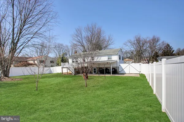 a view of house with a backyard