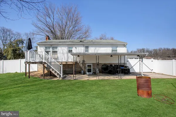 a view of a house with backyard porch and sitting area