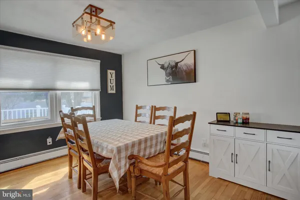 a view of a dining room with furniture and wooden floor