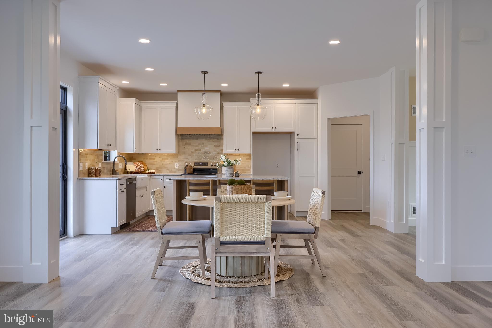 514 Woodcrest Avenue Lititz, PA 17543 - Photo 14 of 64 a kitchen with a dining table chairs wooden floor cabinets and stainless steel appliances