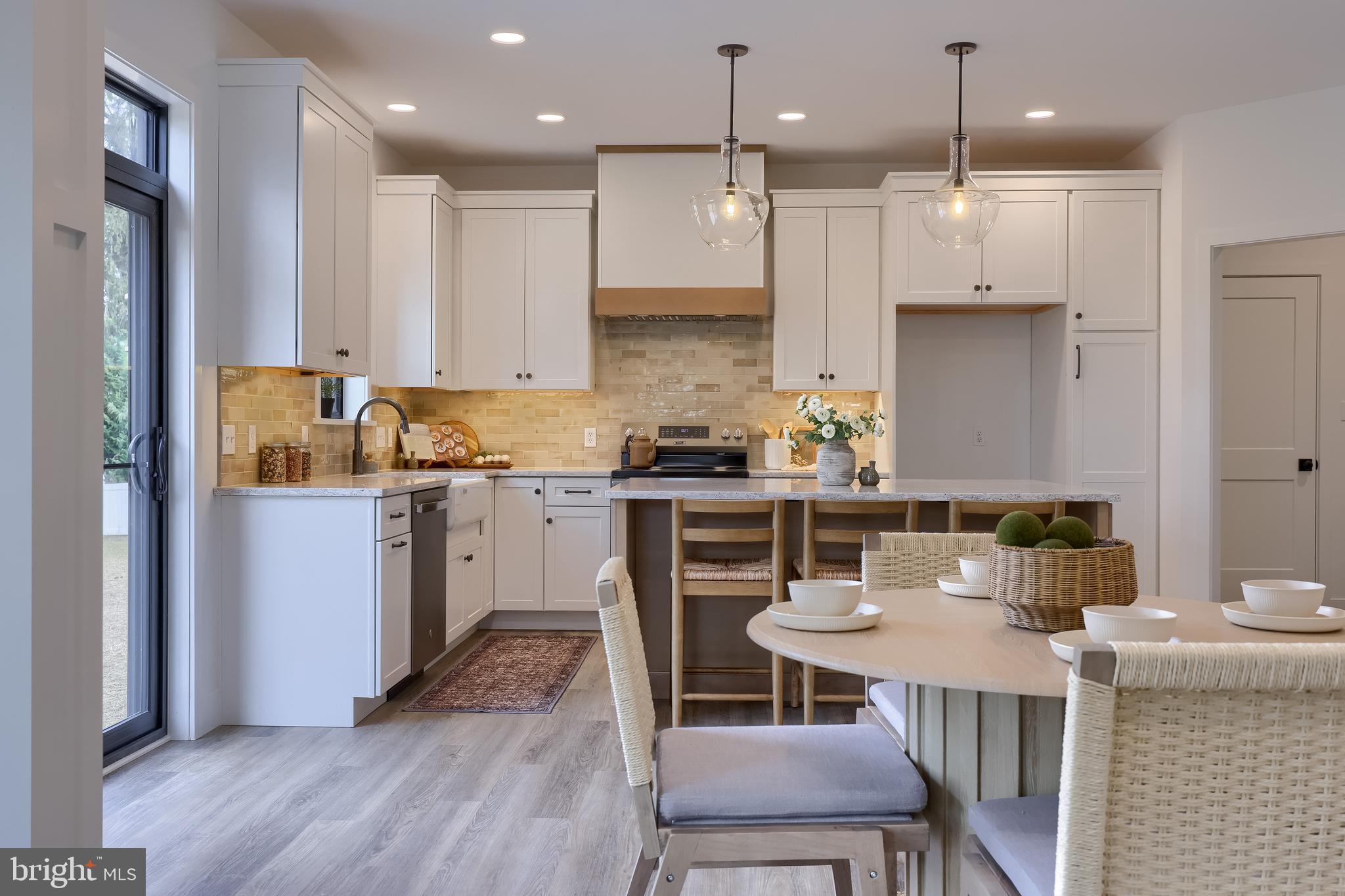 514 Woodcrest Avenue Lititz, PA 17543 - Photo 17 of 64 a kitchen with a table chairs refrigerator and microwave
