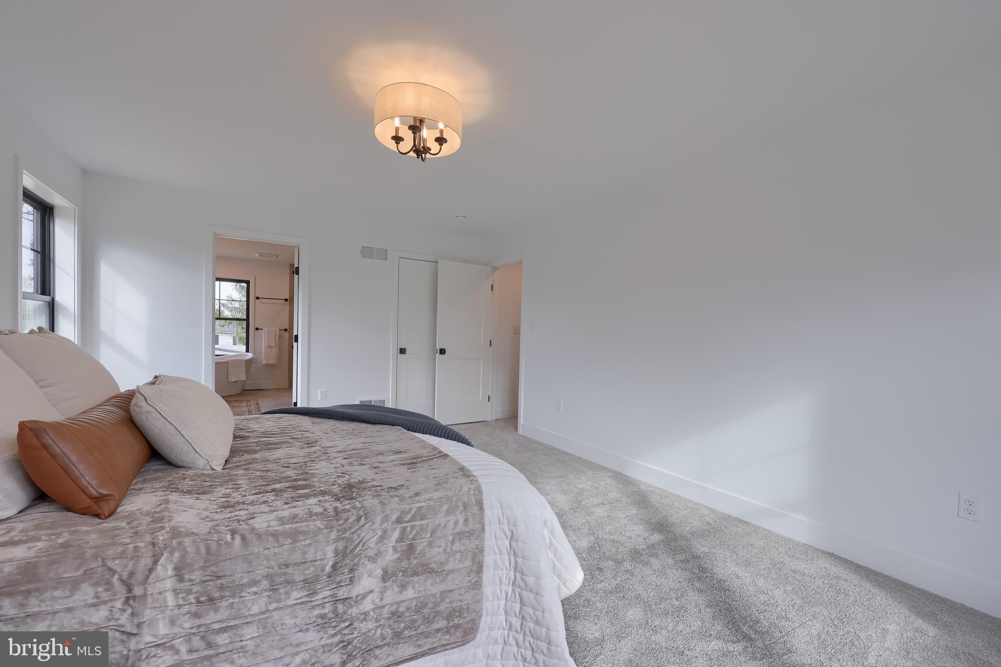 514 Woodcrest Avenue Lititz, PA 17543 - Photo 47 of 64 a bedroom with a bed and a chandelier