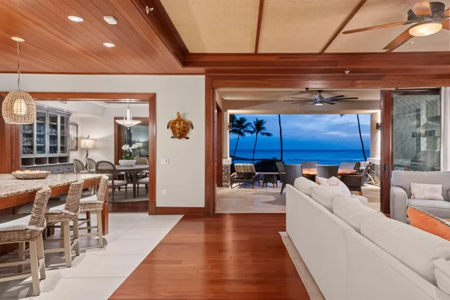 a living room with furniture a rug and a dining table
