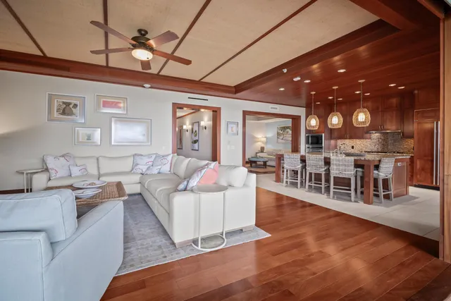 a living room with lots of furniture and view of kitchen