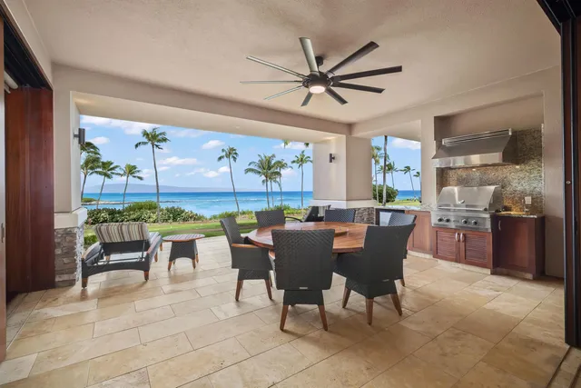 a dining room with furniture and a large window