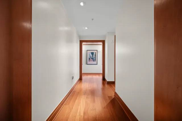 a view of gallery with wooden floor