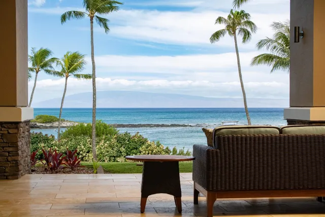 a terrace with a table and chairs and potted plants