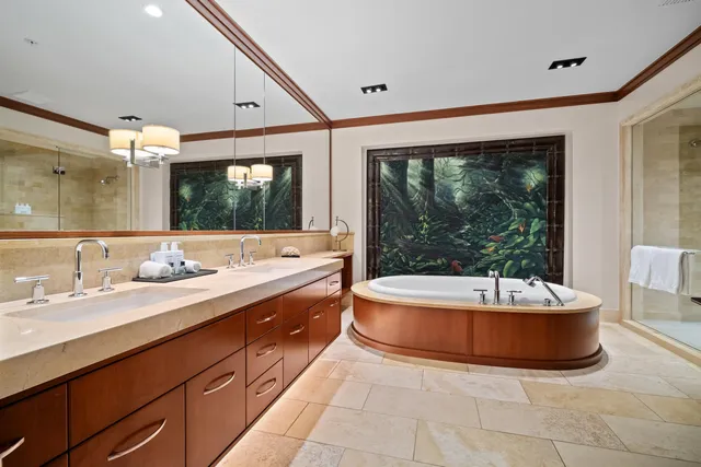 a spacious bathroom with a tub double sink and a large mirror