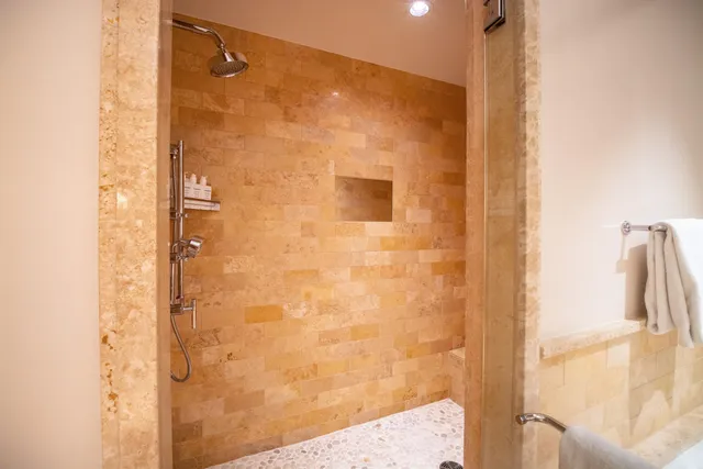 a bathroom with a shower and a glass door