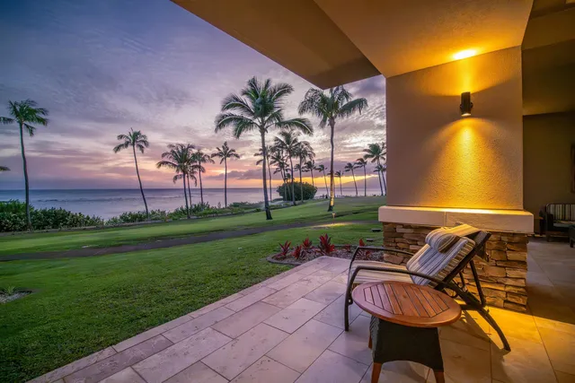 a view of a patio with couches chairs and a yard
