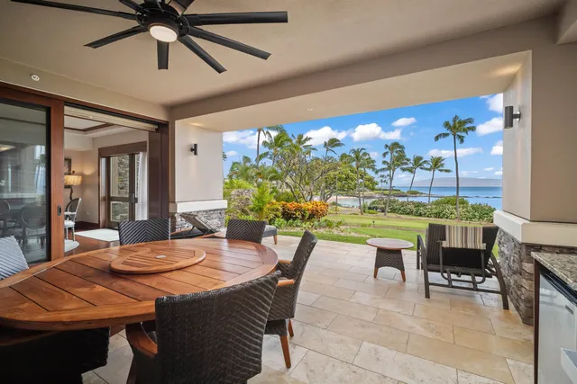 a dining room with furniture and a floor to ceiling window