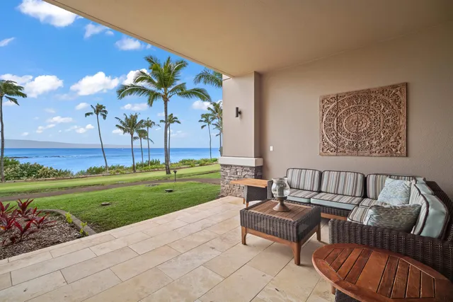 a view of a backyard with couches and swimming pool