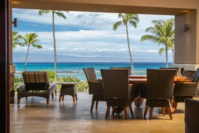 a dining room with furniture a chandelier and wooden floor