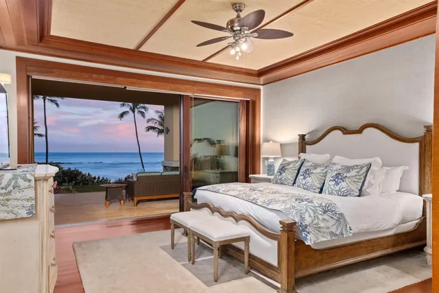 a bedroom with a large bed and a chandelier