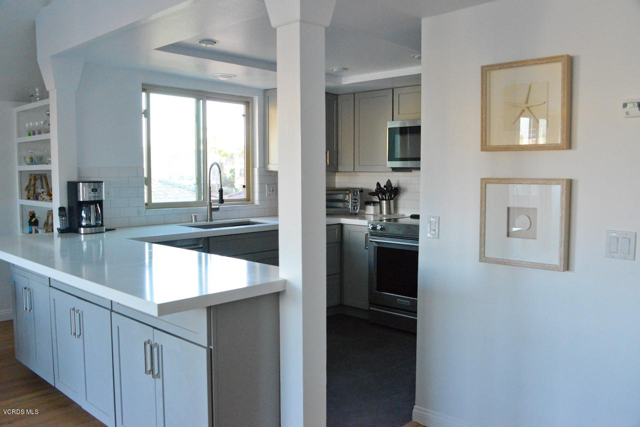 3624 Sunset Lane Oxnard, CA 93035 - Photo 15 of 26 a kitchen with kitchen island a counter top space and a sink