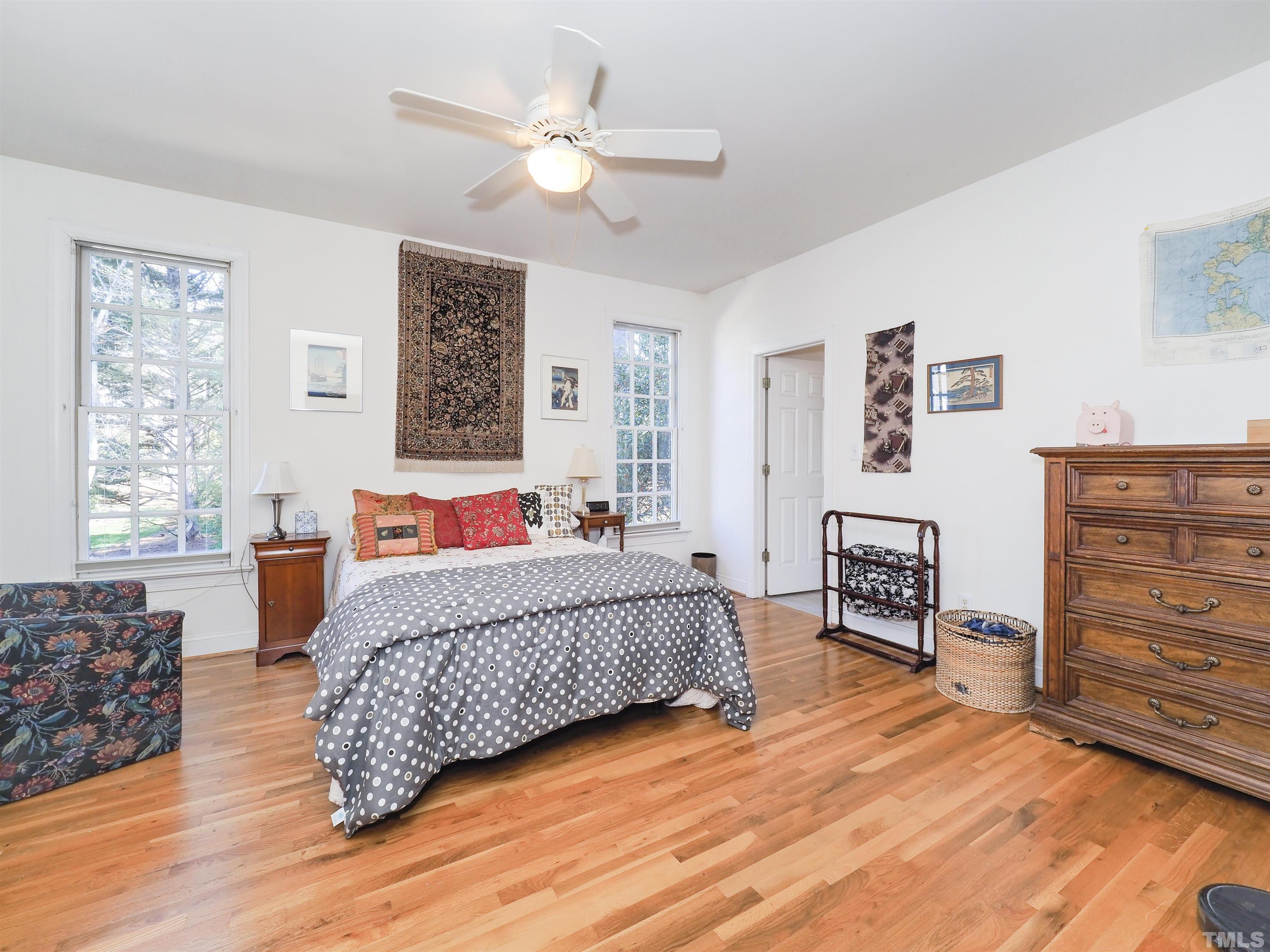 42 Cheswick Place Durham, NC 27707 - Photo 19 of 27 a bedroom with a bed dresser and wooden floor
