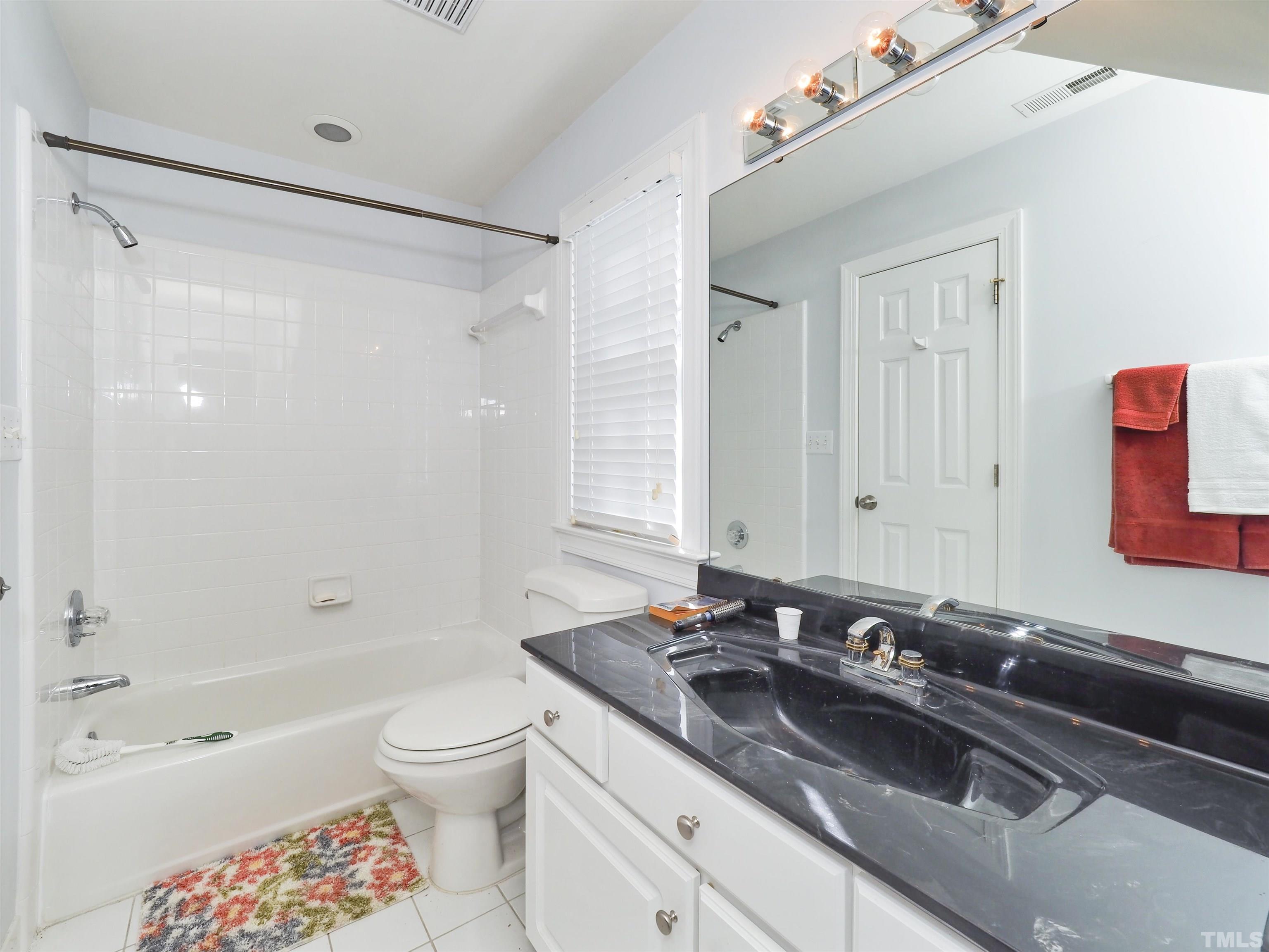 42 Cheswick Place Durham, NC 27707 - Photo 23 of 27 a bathroom with a granite countertop sink a toilet and shower