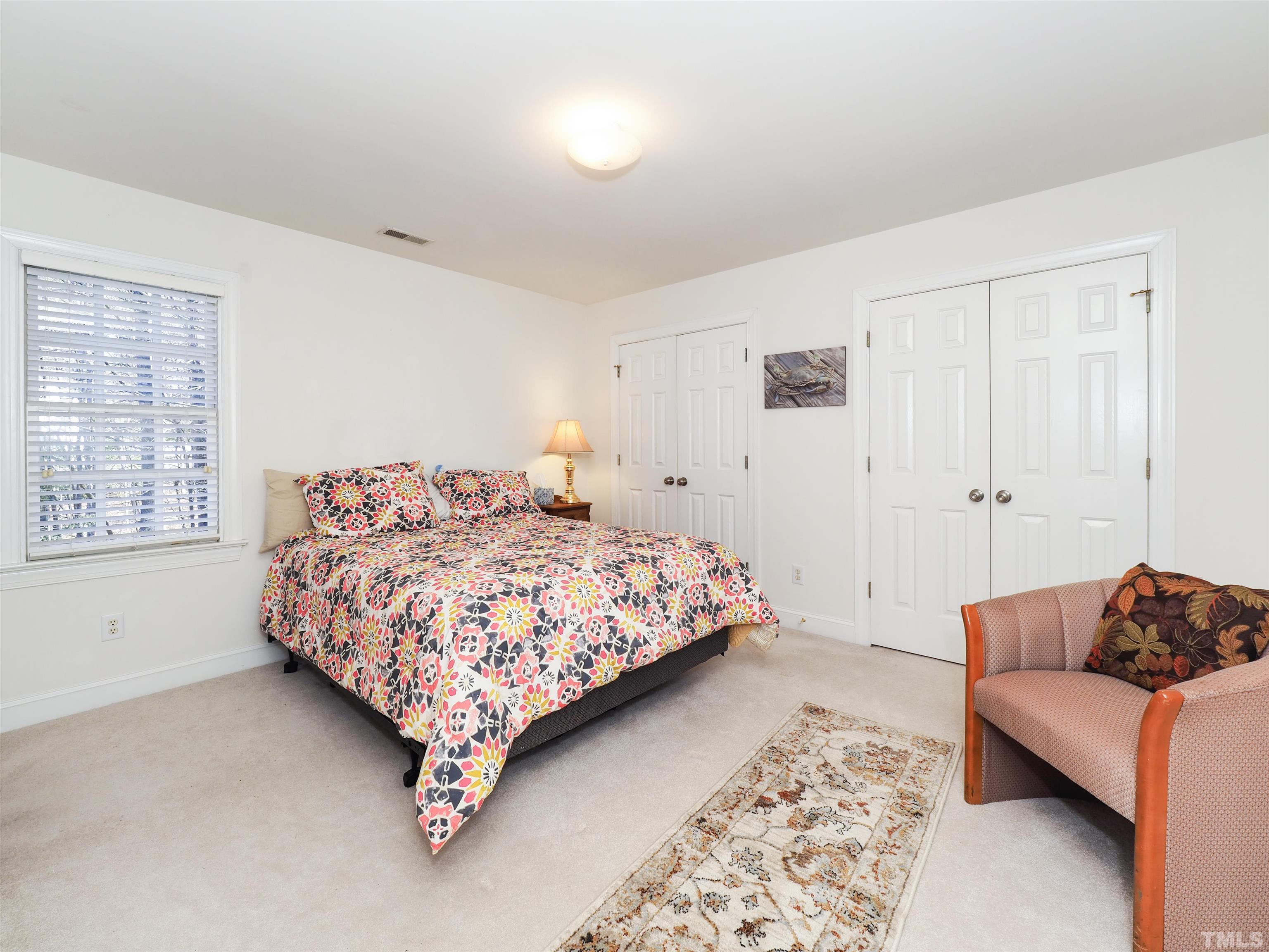 42 Cheswick Place Durham, NC 27707 - Photo 25 of 27 a bedroom with a bed couch and a window