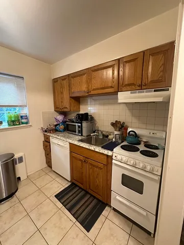 a kitchen with stainless steel appliances a stove a sink and cabinets