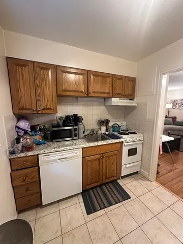 a kitchen with stainless steel appliances granite countertop a stove and a sink