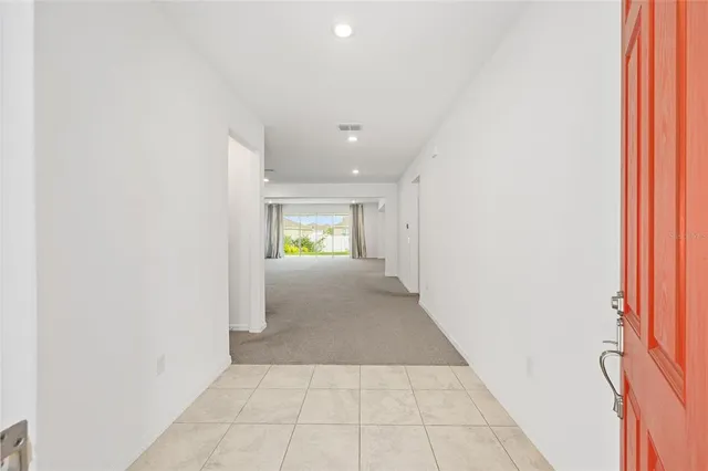 a large kitchen with granite countertop a sink and white cabinets