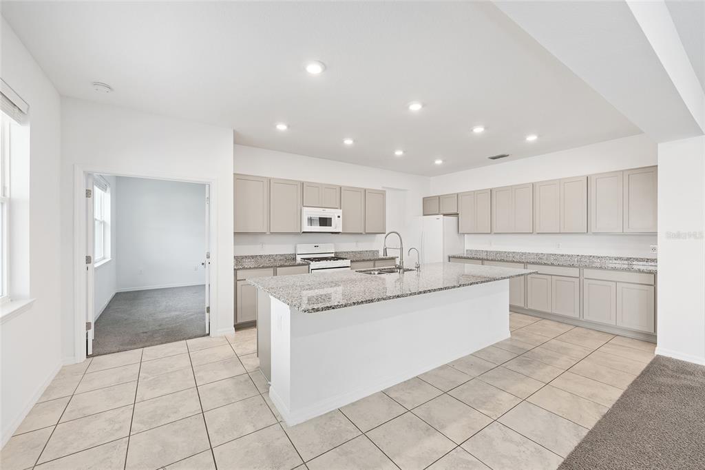 7635 Southwest 64th St Road Ocala, FL 34474 - Photo 14 of 86 a kitchen with white cabinets appliances and a sink