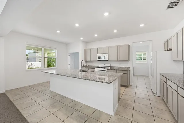 a view of an empty room with stairs and a window