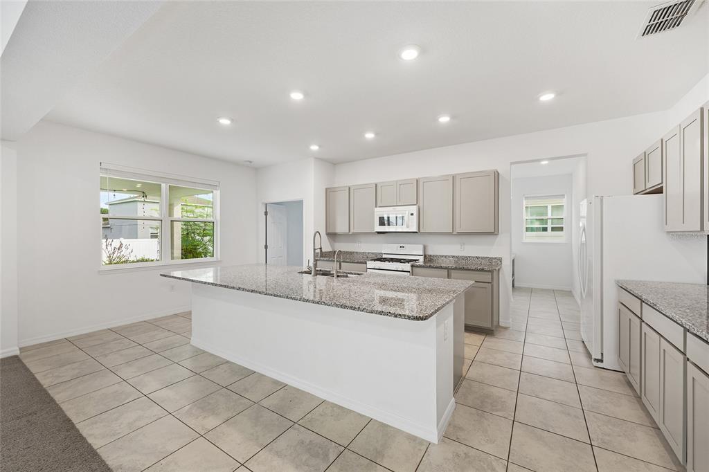 7635 Southwest 64th St Road Ocala, FL 34474 - Photo 16 of 86 a kitchen with stainless steel appliances granite countertop a sink and a stove
