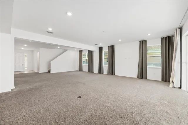 an empty room with windows and closet