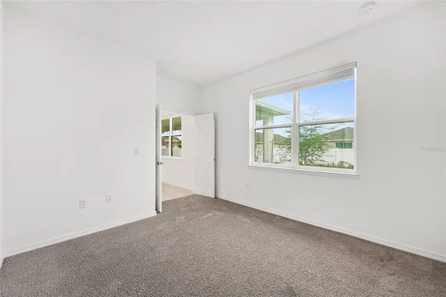 a spacious bathroom with a bathtub sink and mirror