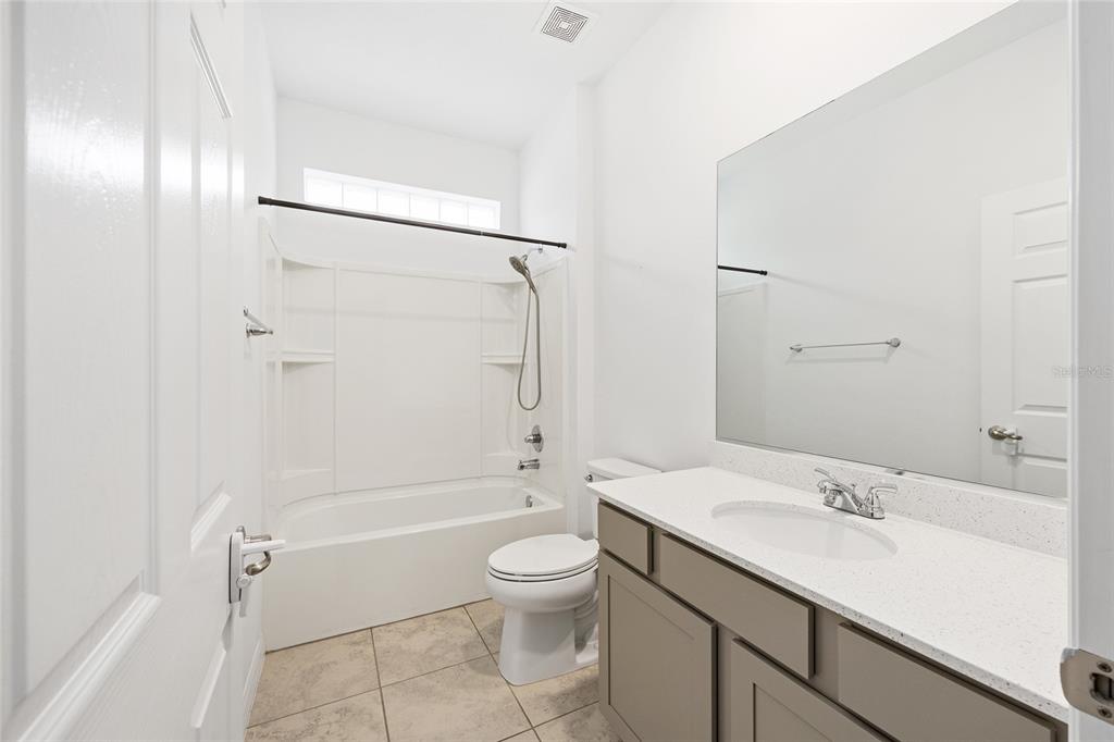 7635 Southwest 64th St Road Ocala, FL 34474 - Photo 41 of 86 a bathroom with a granite countertop sink a toilet and shower