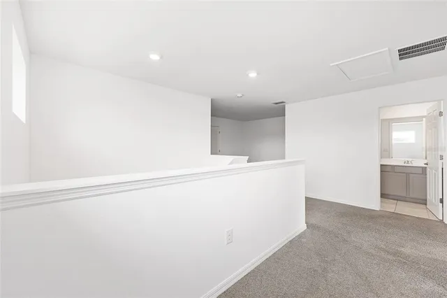 an aerial view of residential houses with outdoor space and parking