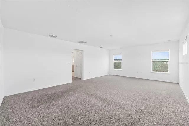 an aerial view of residential houses with outdoor space and river