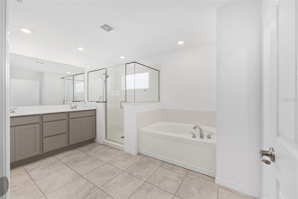 7635 Southwest 64th St Road Ocala, FL 34474 - Photo 49 of 86 a spacious bathroom with a bathtub sink and mirror
