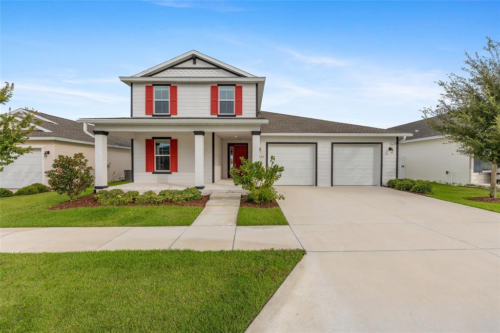 7635 Southwest 64th St Road Ocala, FL 34474 - Photo 7 of 86 a front view of a house with a yard and garage
