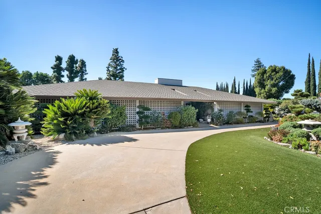 a view of a garden with a building in the background
