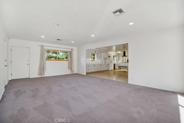 a view of empty room with a fireplace