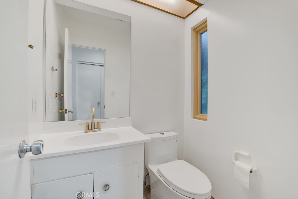 18912 Blackhawk Street Porter Ranch, CA 91326 - Photo 16 of 48 a bathroom with a sink a toilet and mirror