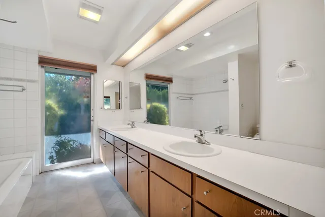 a spacious bathroom with a toilet sink and a mirror